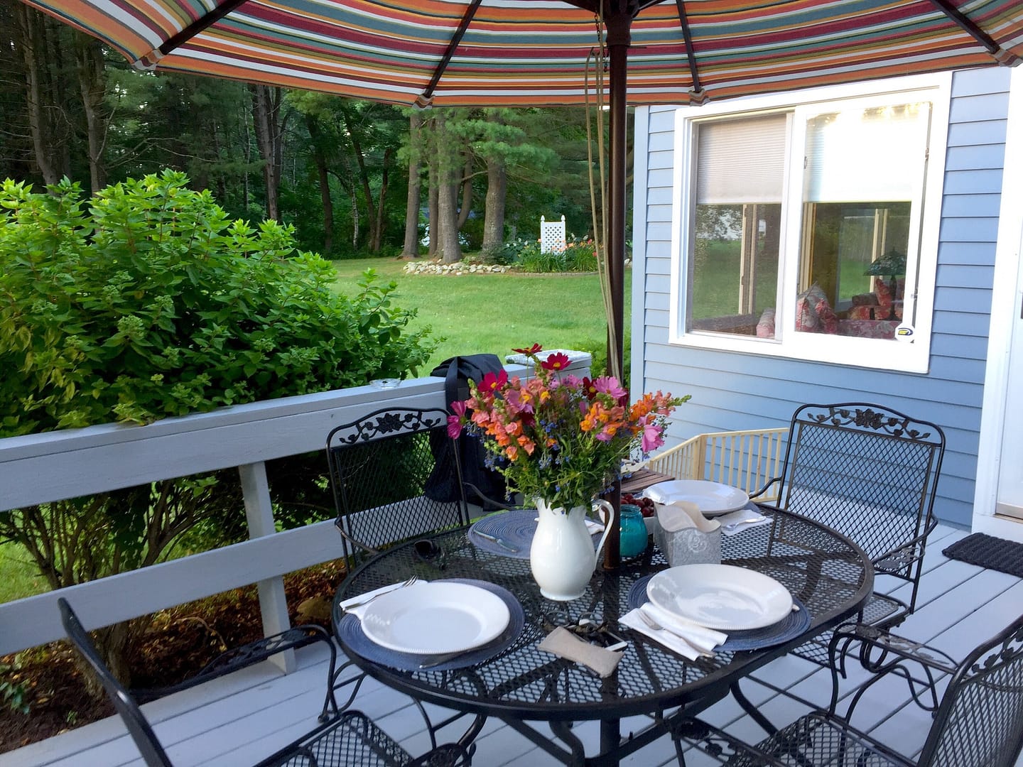 An outdoor living space is set for dinner.