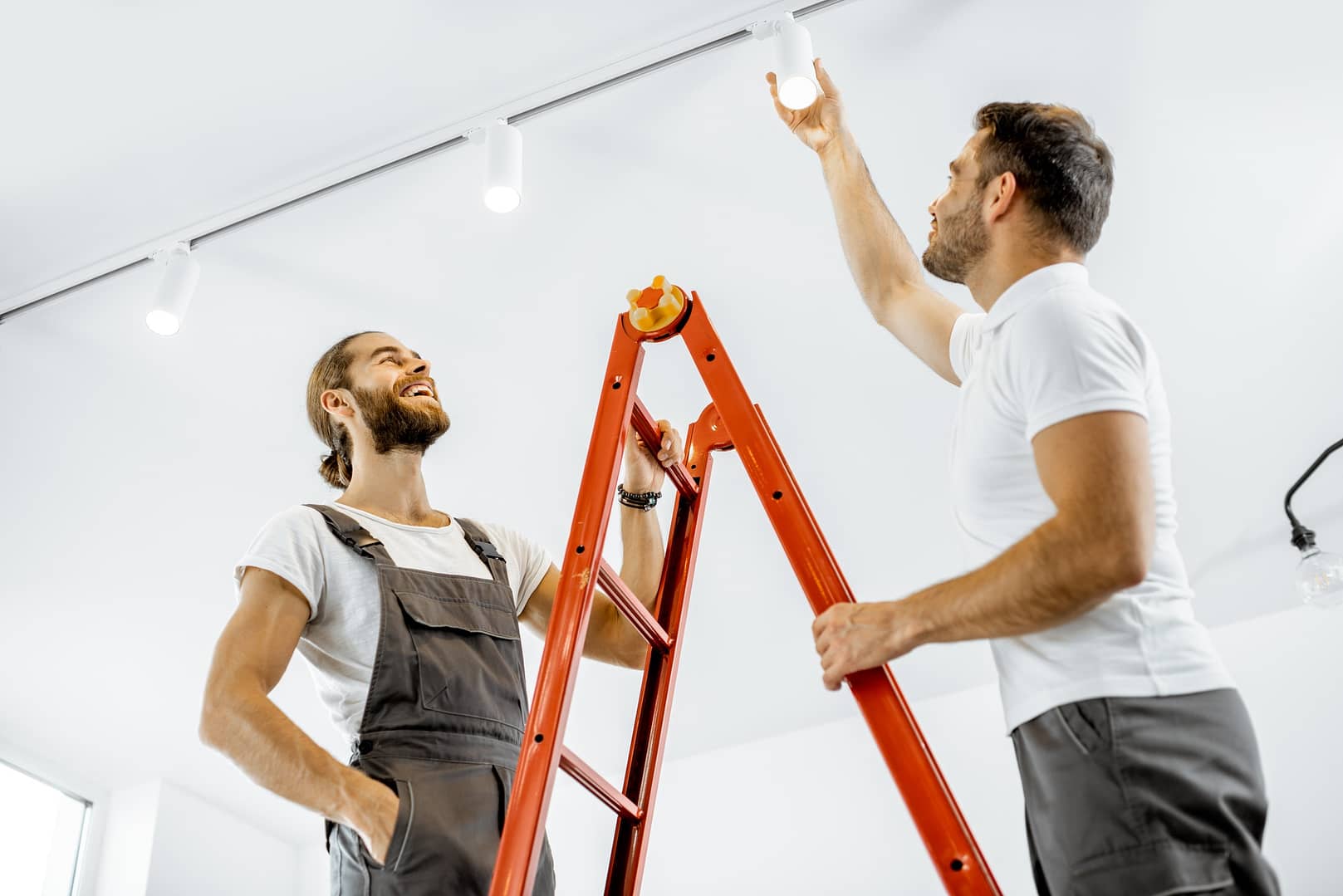 Men installing lights at home