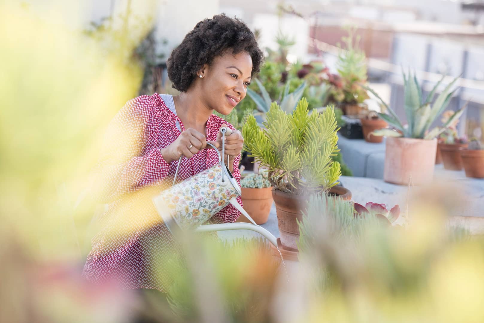 Woman watering her rooftop garden