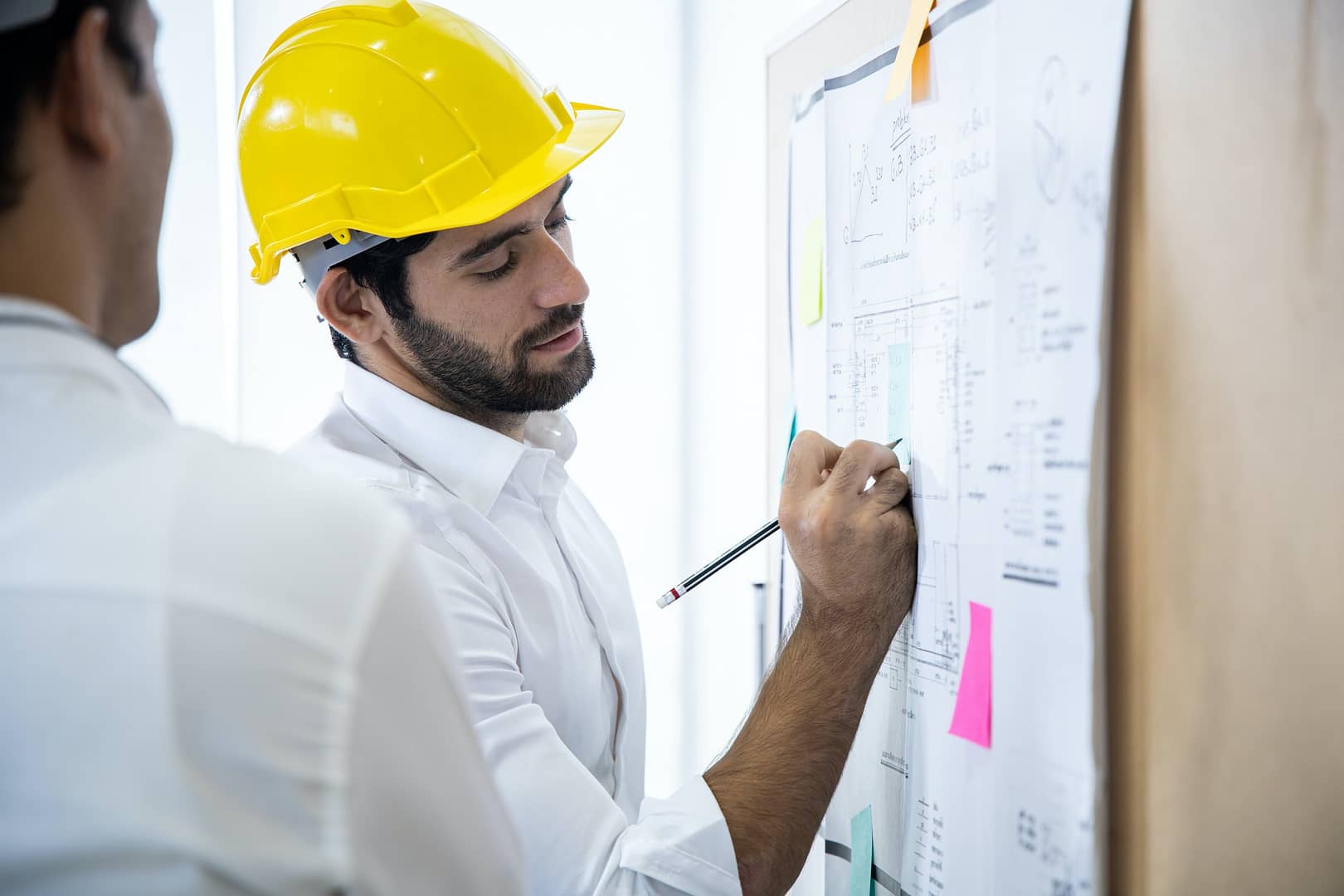 Young engineer plans project structure on the board.