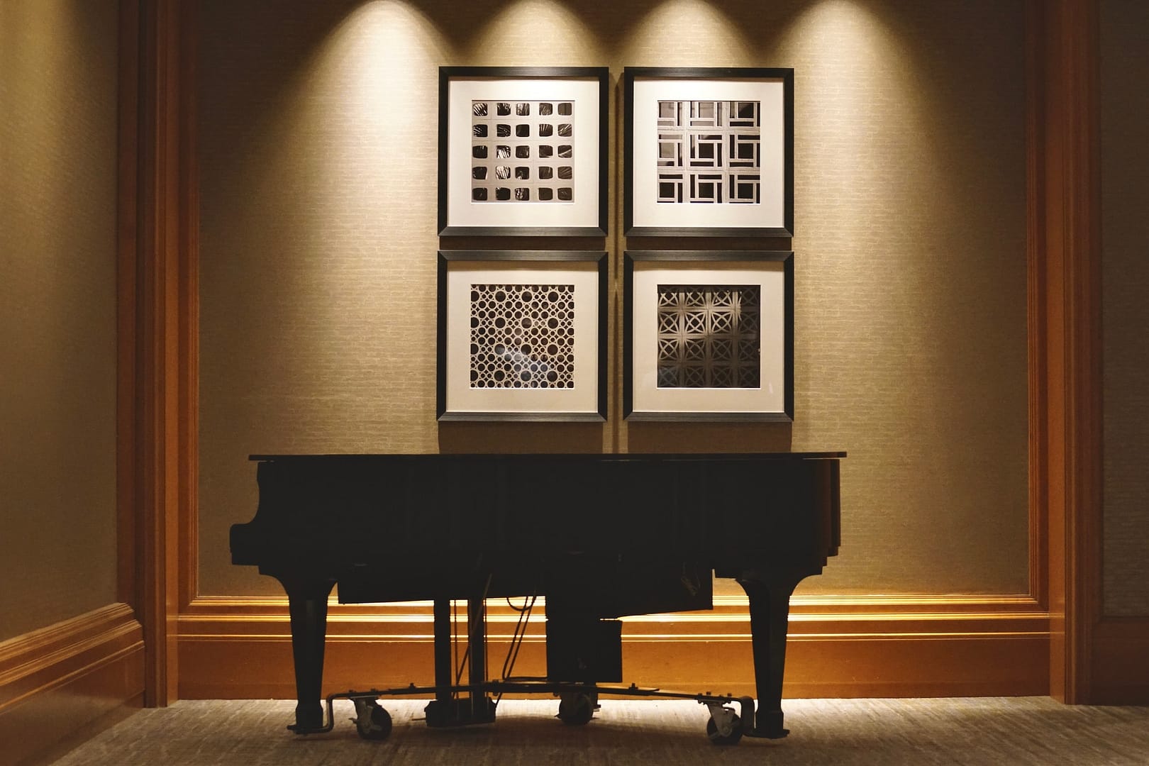 Beautiful modern room with modern art and lighting and a great silhouetted piano