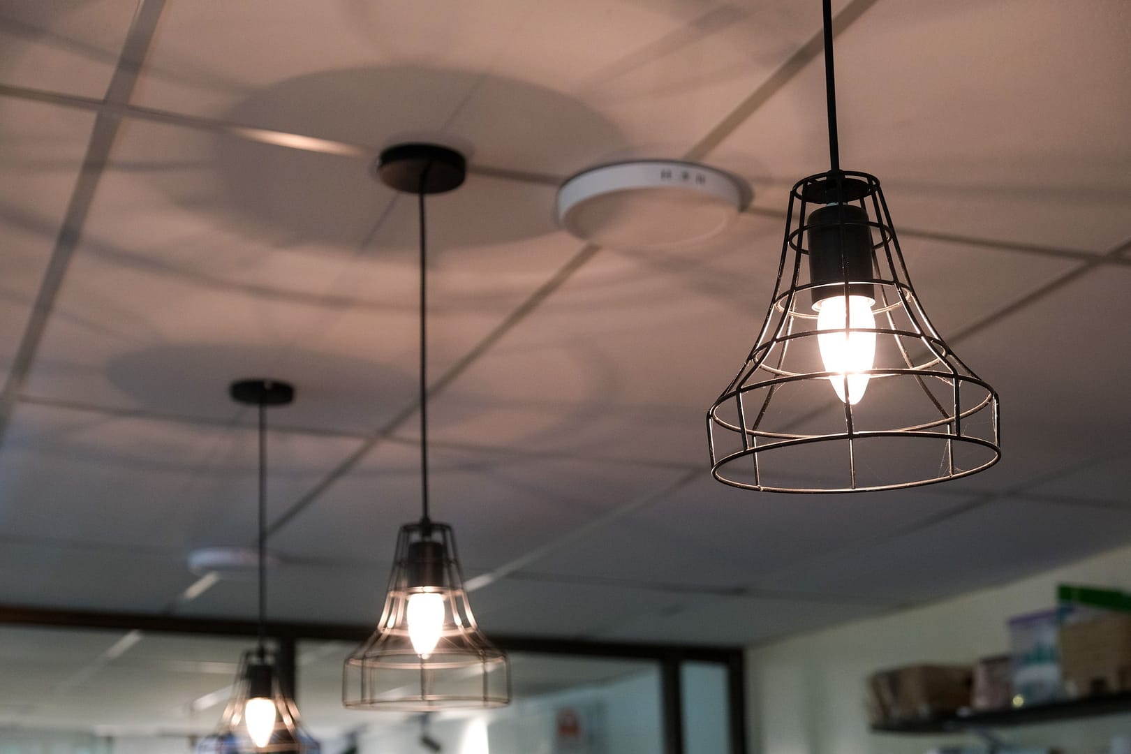 an industrial looking space that has multiple lamps hanging above it