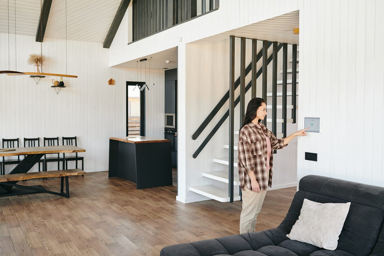 Young woman looking at home security panel or screen