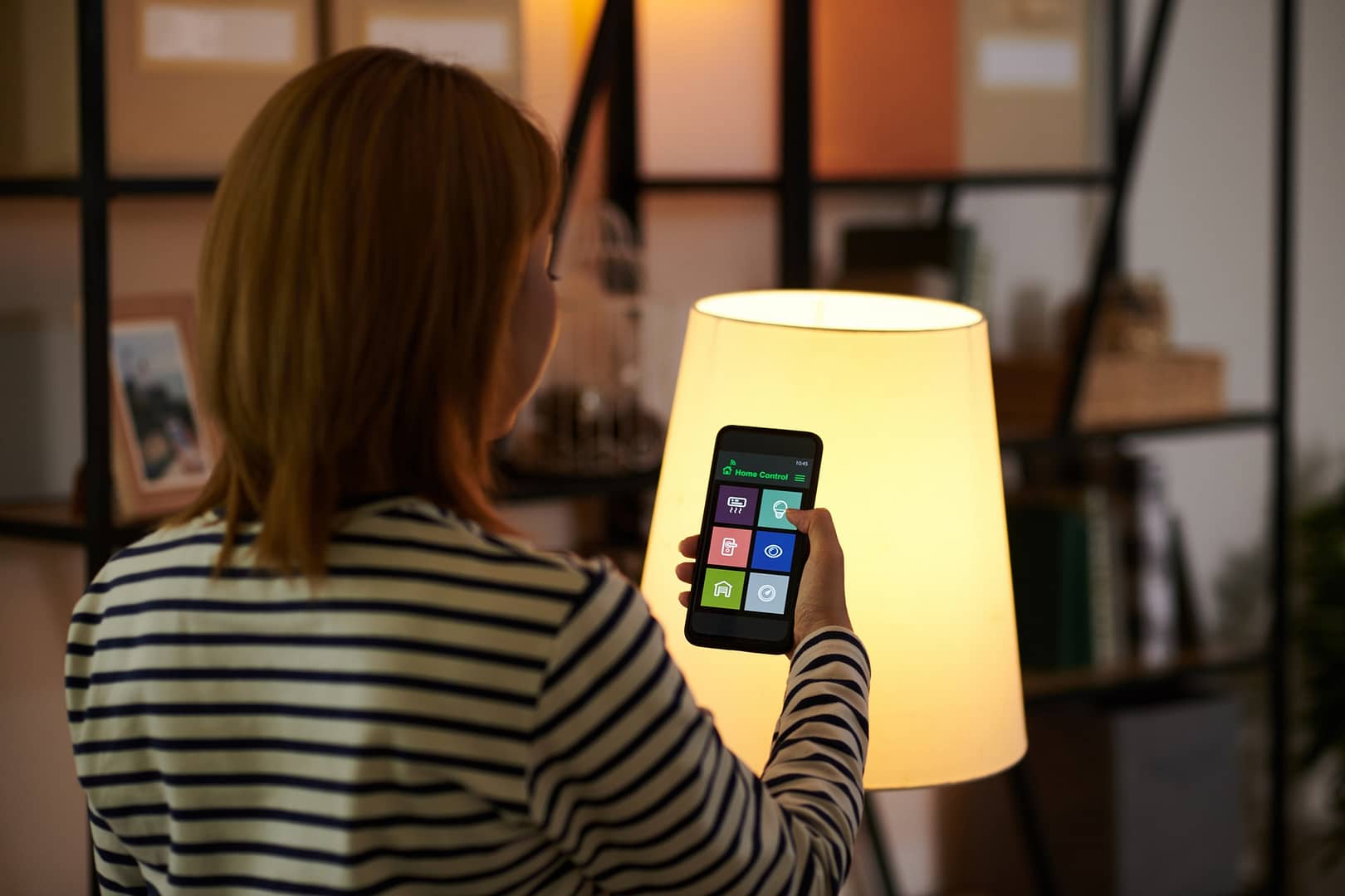 Woman Dimming Lights in Room