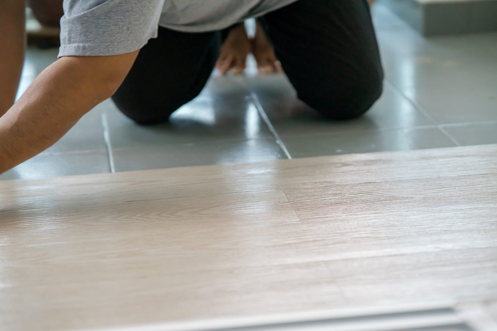 Vinyl floor installation, worker, DIY at home.