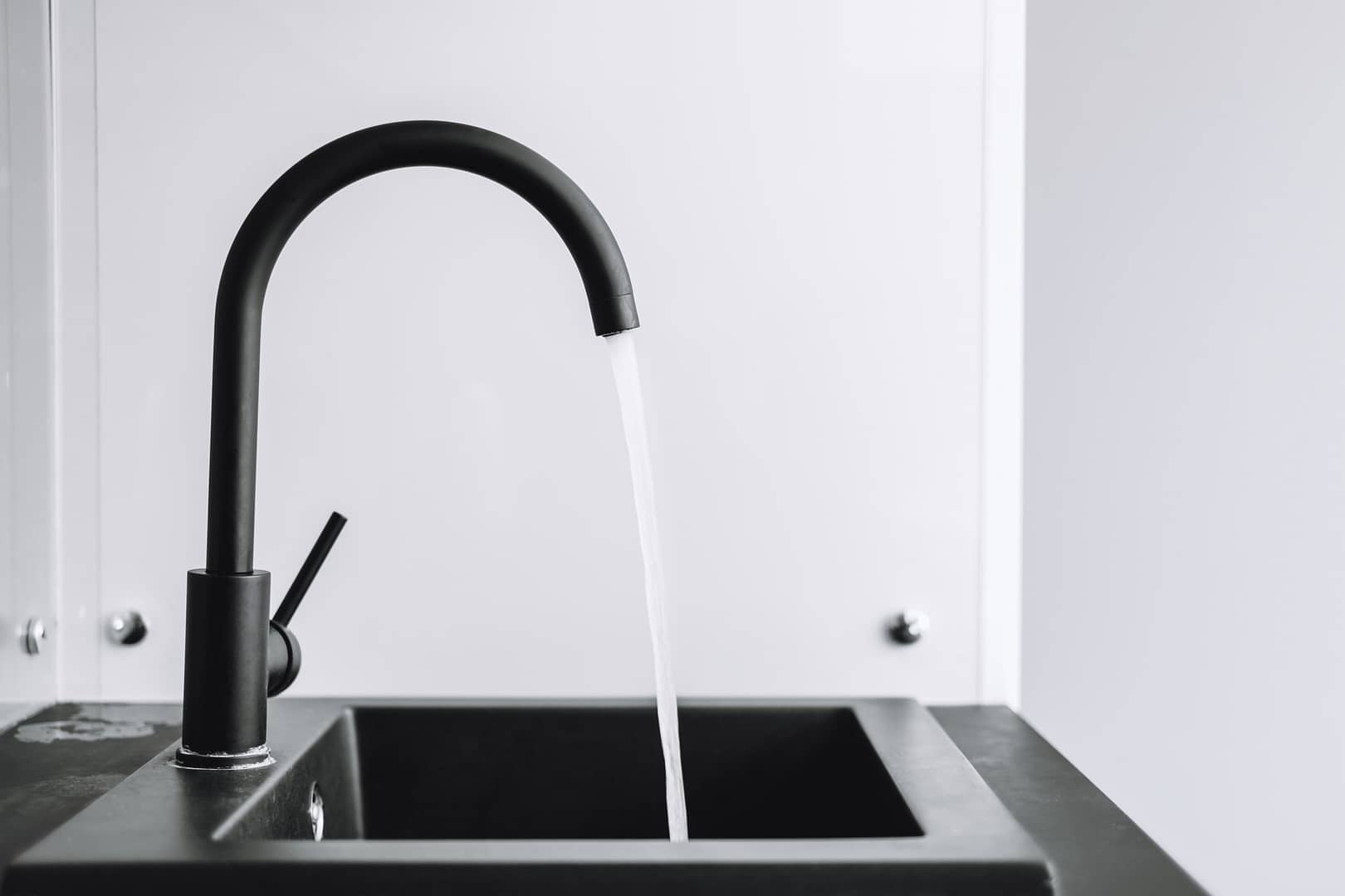 A running tap with the water running in the kitchen.