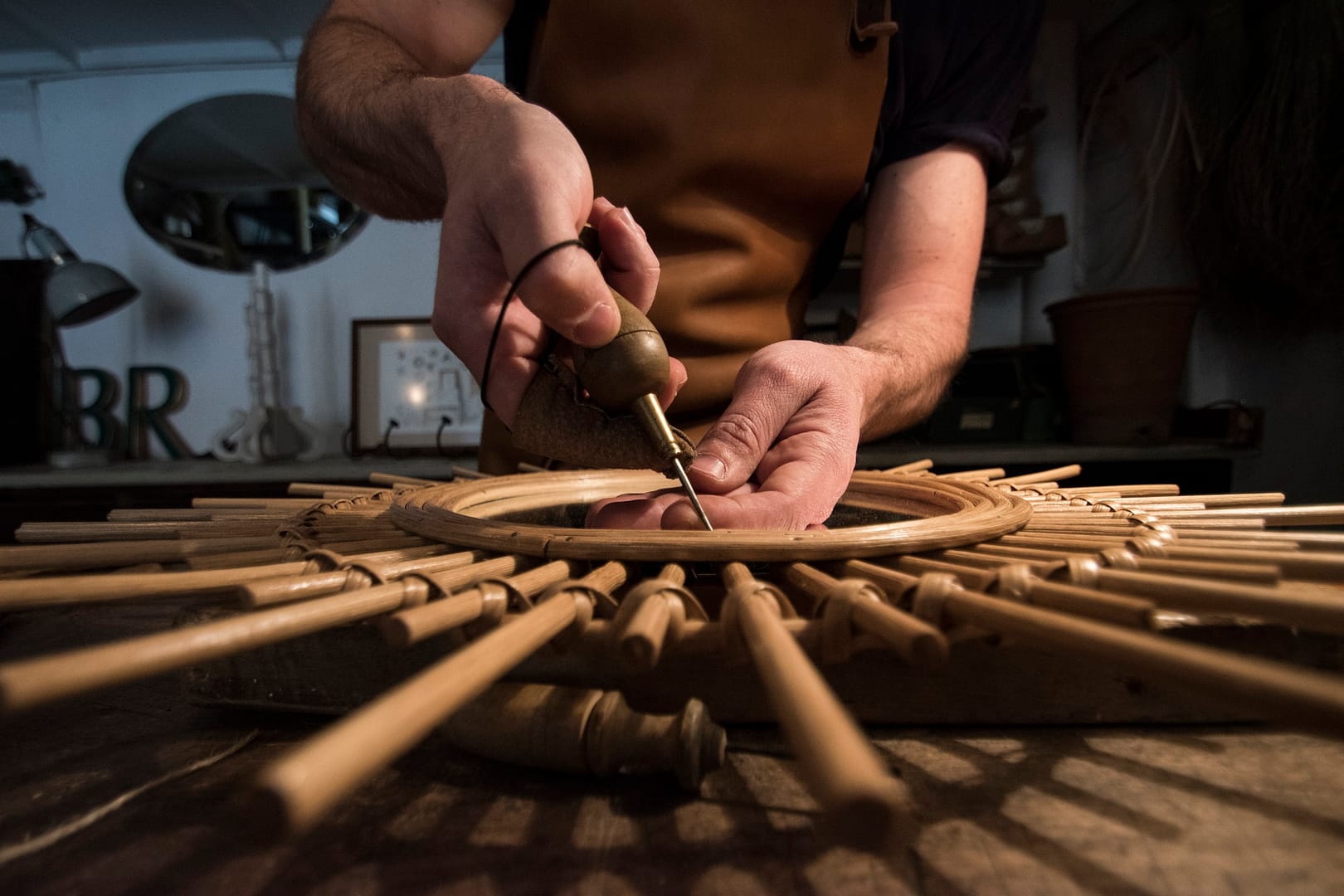 Craftsman manufacturing a mirror in his workshop