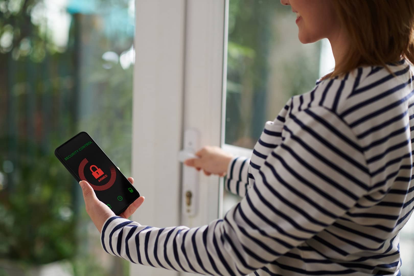 Woman Setting Home Security System