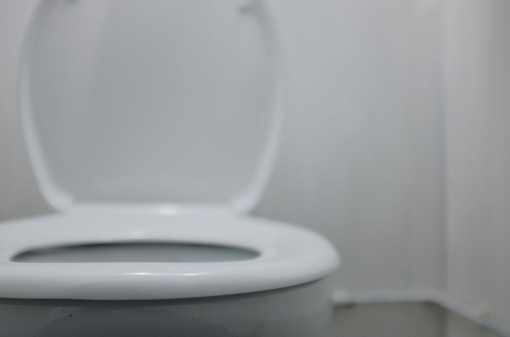 white restroom, toilet, toilet paper and sink composition