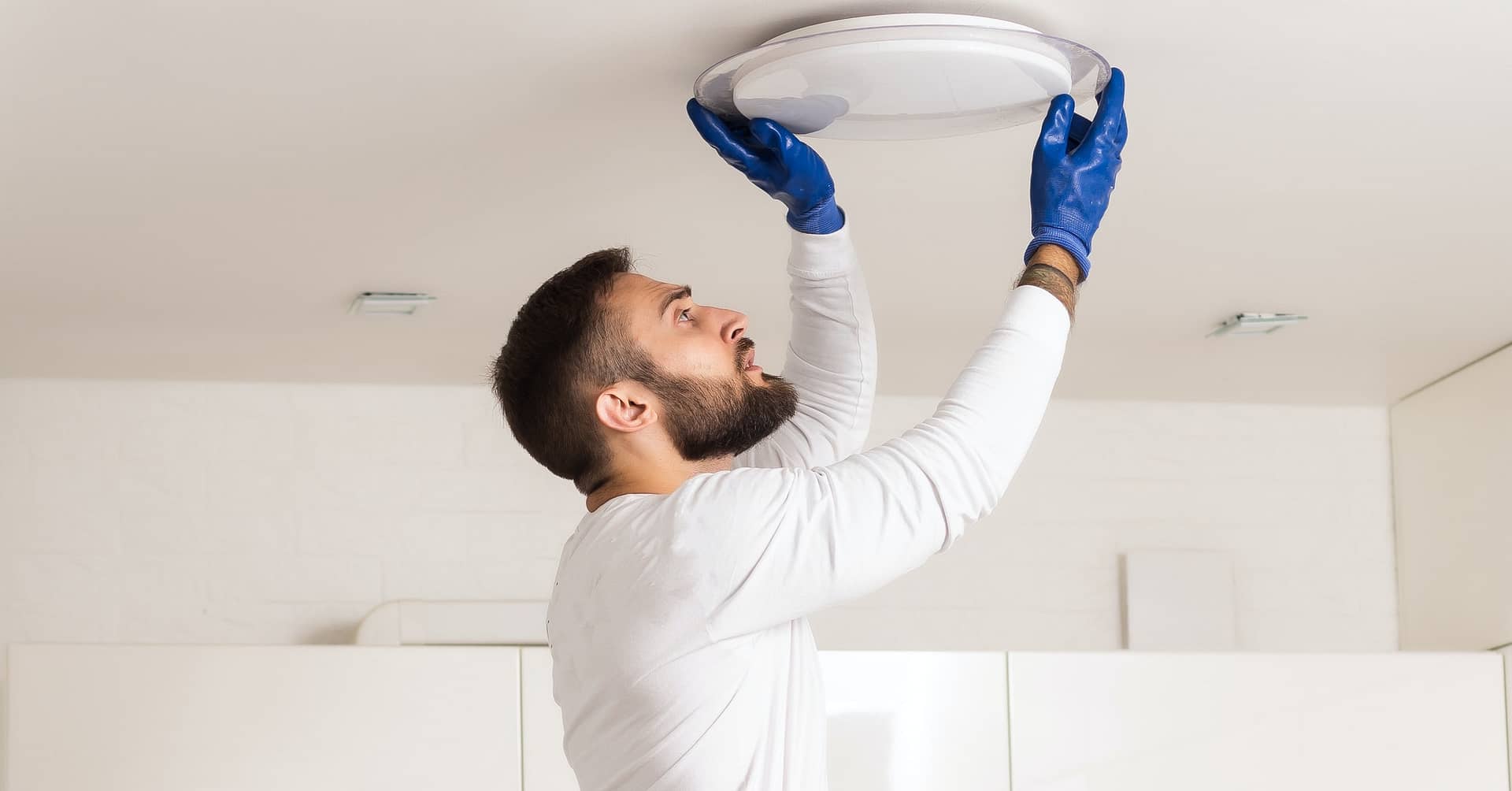 Man Fixing Light At Home.